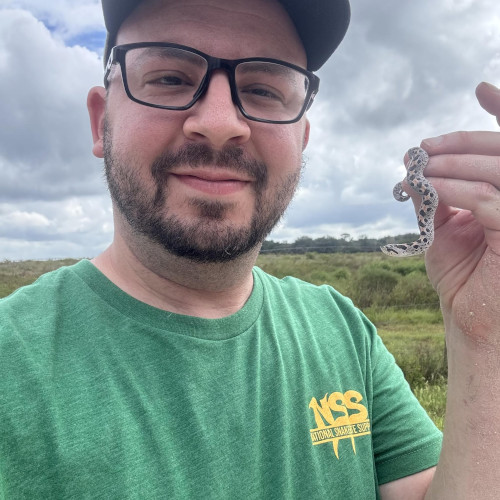 Dr. Cory Woliver holding a hognose snake